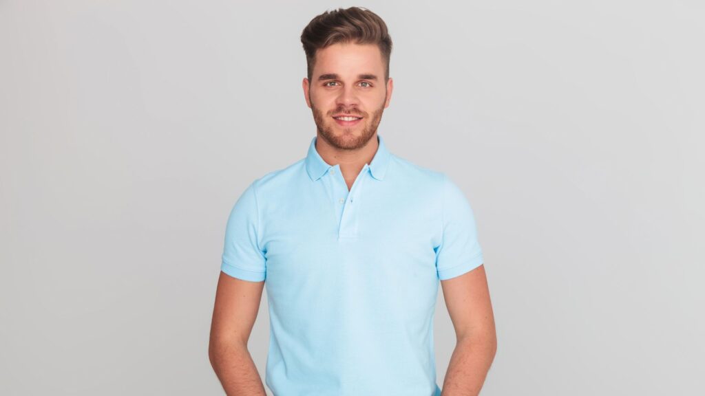 An image showcasing a stylish outfit for men to wear to a baby shower, featuring a light blue button-up shirt, khaki pants, and brown loafers." with the keyword what to wear to a baby shower included.