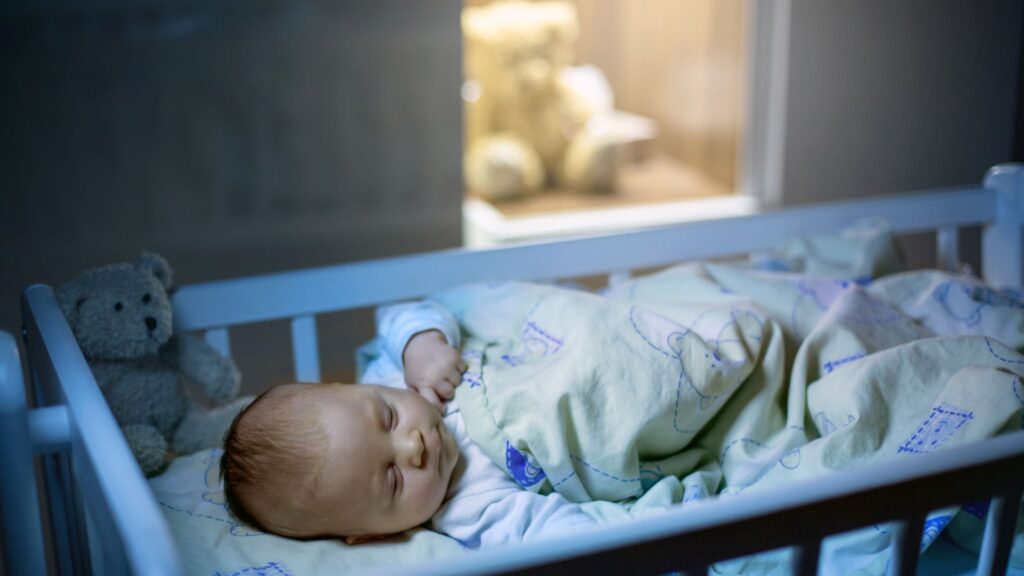 A newborn baby sleeping in a crib